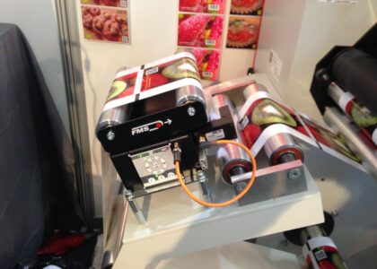 BKS015 web guiding system displayed at Labelexpo 2015, showcasing precision label control technology.