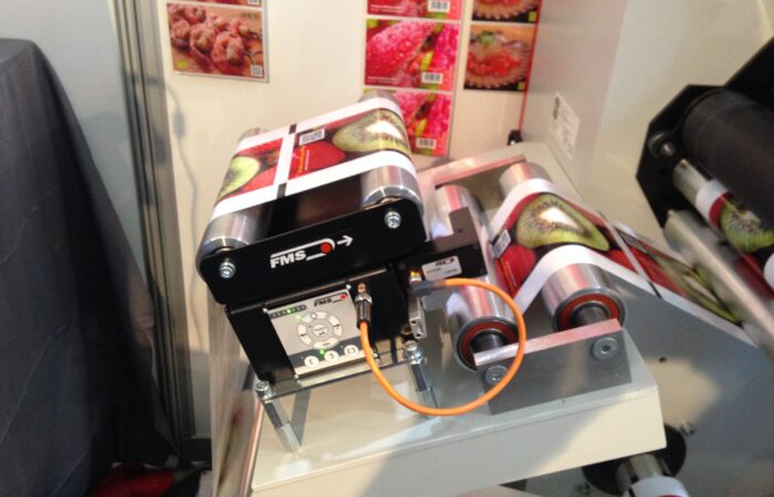 BKS015 web guiding system displayed at Labelexpo 2015, showcasing precision label control technology.