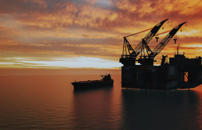 Offshore oil and gas rig at sunset, showcasing energy production and maritime transportation.